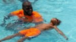 Commanders left tackle Cornelius Lucas teaches boys how to swim Commanders left tackle Cornelius Lucas teaches boys how to swim